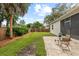 Well-maintained backyard with a brick patio area, privacy fence, and lush landscaping at 3605 W Paxton Ave, Tampa, FL 33611