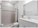 Bright bathroom featuring a glass-enclosed shower with tile walls and a granite vanity at 3605 W Paxton Ave, Tampa, FL 33611