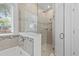 Bright bathroom featuring a soaking tub and a glass-enclosed shower at 3605 W Paxton Ave, Tampa, FL 33611
