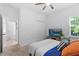 A bright bedroom featuring a TV and ceiling fan, accentuated by natural light at 3605 W Paxton Ave, Tampa, FL 33611