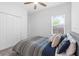 Bright bedroom featuring a ceiling fan, a window, and a neutral color scheme at 3605 W Paxton Ave, Tampa, FL 33611