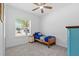 Cozy bedroom featuring neutral paint, carpet, a ceiling fan, closet, and a window with natural light at 3605 W Paxton Ave, Tampa, FL 33611