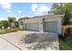 Charming single story home featuring a well-manicured lawn, a two car garage, and tropical landscaping at 3605 W Paxton Ave, Tampa, FL 33611