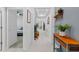 Hallway features neutral paint, trim, decor and tile flooring, leading to bedrooms, dining room and front door at 3605 W Paxton Ave, Tampa, FL 33611