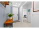 Hallway features neutral paint, trim, decor and tile flooring, leading to bedrooms, dining room and front door at 3605 W Paxton Ave, Tampa, FL 33611