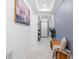 Bright hallway with natural light, tray ceiling, tile flooring, and blue accent wall at 3605 W Paxton Ave, Tampa, FL 33611