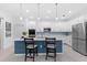 Spacious kitchen with stainless steel appliances, a marble island, and stylish pendant lighting at 3605 W Paxton Ave, Tampa, FL 33611