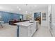 Modern kitchen with white cabinets, stainless steel appliances, and a spacious island for entertaining at 3605 W Paxton Ave, Tampa, FL 33611