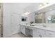 Main bathroom features double sinks, quartz countertops and a separate shower and tub at 3605 W Paxton Ave, Tampa, FL 33611
