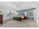 Bedroom with blue accent wall, carpeted flooring, and natural light at 3605 W Paxton Ave, Tampa, FL 33611