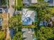 Aerial view of a home showcasing a lush backyard with pool and unique roof design at 3711 W Barcelona St, Tampa, FL 33629