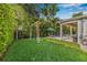 A lush backyard with green lawn and a swing at 3711 W Barcelona St, Tampa, FL 33629