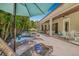 Relax on this backyard's covered patio, complete with chaise lounges, seating, and dining options at 3711 W Barcelona St, Tampa, FL 33629