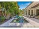 Backyard features a pool and spa, complimented by a patio, seating, and a green lawn at 3711 W Barcelona St, Tampa, FL 33629