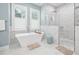 Elegant bathroom featuring a freestanding tub, walk-in shower, and bright windows at 3711 W Barcelona St, Tampa, FL 33629