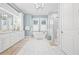 Spacious bathroom with a soaking tub, walk-in shower, double vanity, and marble tile flooring at 3711 W Barcelona St, Tampa, FL 33629
