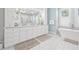 Luxurious bathroom featuring double vanities, soaking tub, walk-in shower, and plenty of natural light at 3711 W Barcelona St, Tampa, FL 33629