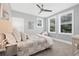 Charming bedroom with plush carpet, ceiling fan, and natural light from windows at 3711 W Barcelona St, Tampa, FL 33629