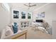 Light-filled bonus room featuring a comfortable seating area, desk, and ample natural light from large windows at 3711 W Barcelona St, Tampa, FL 33629