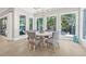 This breakfast nook has large windows overlooking tropical landscaping and pool at 3711 W Barcelona St, Tampa, FL 33629