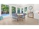 Bright breakfast nook with large windows overlooking tropical landscaping and pool at 3711 W Barcelona St, Tampa, FL 33629