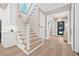 Inviting entryway featuring wood floors, a staircase, and a view into other rooms with neutral paint at 3711 W Barcelona St, Tampa, FL 33629