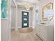 Bright foyer featuring wood floors, a stylish pendant light, and views into the adjacent living spaces at 3711 W Barcelona St, Tampa, FL 33629