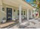 Inviting front porch with classic columns, rocking chairs, and a charming entrance with potted plants at 3711 W Barcelona St, Tampa, FL 33629