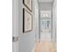 Hallway view leads to a luxurious bathroom with a soaking tub and modern fixtures at 3711 W Barcelona St, Tampa, FL 33629