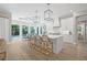 Elegant white kitchen with a large center island, pendant lighting, and barstool seating at 3711 W Barcelona St, Tampa, FL 33629