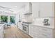 Well-appointed kitchen featuring a stainless steel range, custom hood, and stylish white cabinetry at 3711 W Barcelona St, Tampa, FL 33629