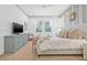 This bright primary bedroom features a ceiling fan, three large windows, and luxury vinyl floors at 3711 W Barcelona St, Tampa, FL 33629