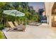 Outdoor lounge area featuring comfortable seating, a relaxing pool, and lush tropical landscaping for privacy at 3711 W Barcelona St, Tampa, FL 33629