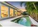 A stunning outdoor pool and spa area with comfortable lounge chairs offer a relaxing retreat in a tropical setting at 3711 W Barcelona St, Tampa, FL 33629