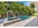 Backyard pool with a spa surrounded by palm trees and lush landscaping at 3711 W Barcelona St, Tampa, FL 33629