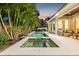 Backyard showcasing a sparkling pool and spa, complemented by a covered patio ideal for relaxation at 3711 W Barcelona St, Tampa, FL 33629