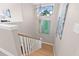 Bright stairway with hardwood steps, white railing, art on the wall, and a decorative light fixture at 3711 W Barcelona St, Tampa, FL 33629