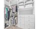 Spacious walk-in closet with multiple shelves, drawers, and rods to maximize storage and organization at 3711 W Barcelona St, Tampa, FL 33629