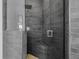 Sleek bathroom featuring dark gray brick-style tiles, a frameless shower, and bench seating at 4612 Barracuda Dr, Bradenton, FL 34208