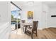 Bright dining area with natural light, modern art, and sliding glass doors to the pool at 4612 Barracuda Dr, Bradenton, FL 34208