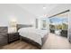 Serene main bedroom featuring wood-look floors, neutral decor, and sliding glass doors to the pool area at 4612 Barracuda Dr, Bradenton, FL 34208
