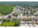 Wide aerial view of a residential neighborhood showcasing lush greenery, ponds, and a single-Gathering home at 4951 Musselshell Dr, New Port Richey, FL 34655