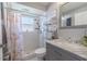 Updated bathroom with a shower-tub combo and a gray vanity with a marble countertop and chrome fixtures at 4951 Musselshell Dr, New Port Richey, FL 34655