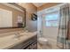 Cozy bathroom featuring a shower-tub combo and a dark wooden vanity with a light-colored countertop at 4951 Musselshell Dr, New Port Richey, FL 34655