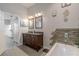 Modern bathroom with a double vanity, soaking tub, and decor accents at 4951 Musselshell Dr, New Port Richey, FL 34655