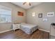 Comfortable bedroom features wood flooring, and a window with blinds at 4951 Musselshell Dr, New Port Richey, FL 34655