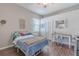 Bright bedroom featuring wood floors and a work desk, offering a comfortable and functional space at 4951 Musselshell Dr, New Port Richey, FL 34655