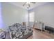 Bedroom with light gray walls, wood floors, and LED lights around the ceiling with TV and dresser at 4951 Musselshell Dr, New Port Richey, FL 34655