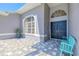 Inviting entrance with tiled walkway, double doors, and a quaint bench creates a welcoming atmosphere at 4951 Musselshell Dr, New Port Richey, FL 34655