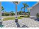 Charming front porch with stylish pavers and a well-manicured garden with tropical foliage at 4951 Musselshell Dr, New Port Richey, FL 34655